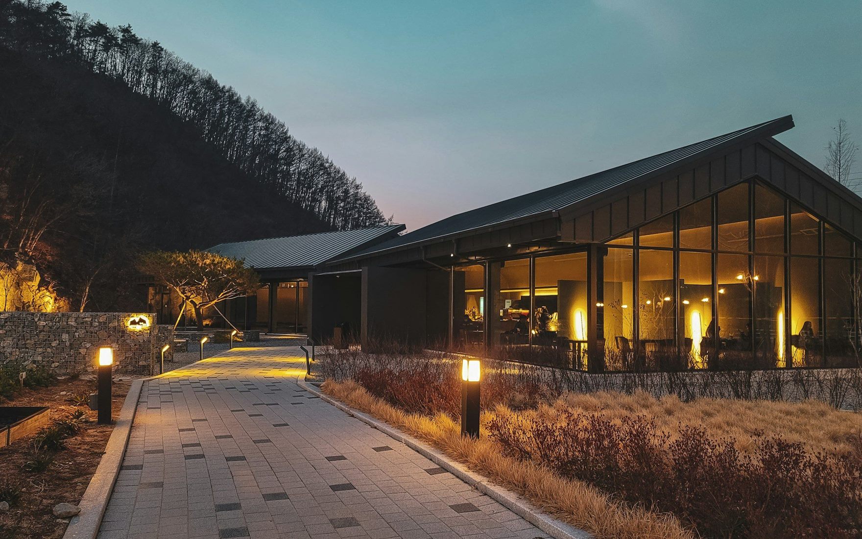The lit entrance courtyard of Selene Court at dusk